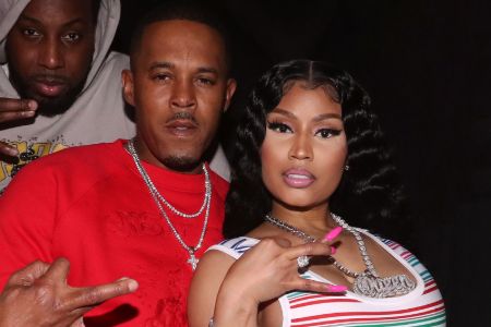 Nicki  Minaj and Kenneth Petty crossing ring finger as a pose in photo